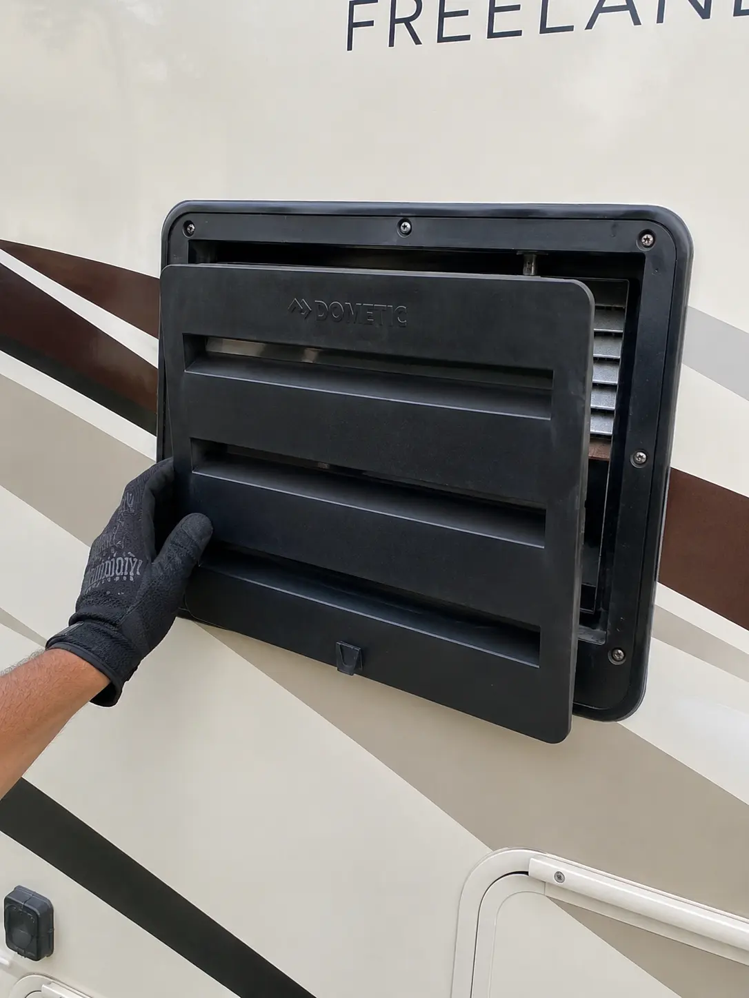RV appliance repair technician working on refrigerator in Louisville KY